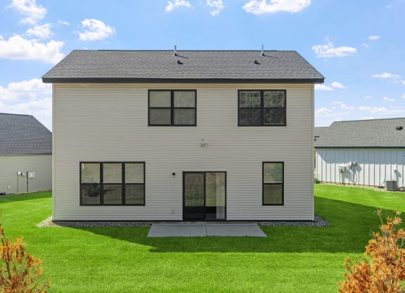 a white house with a lawn in front of it