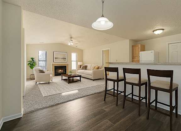 A living room with a fireplace and two chairs.