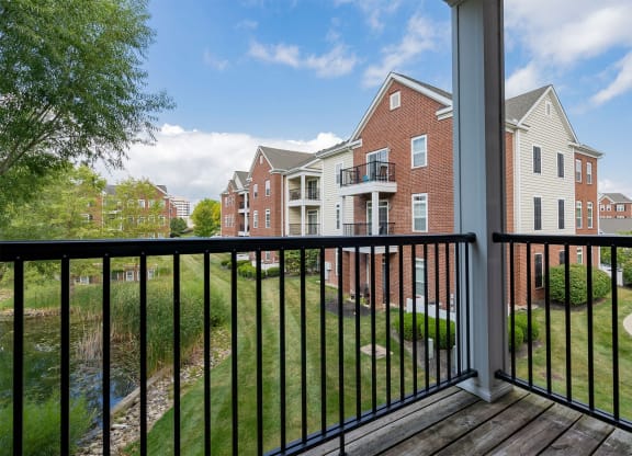 a balcony with a view of an apartment building