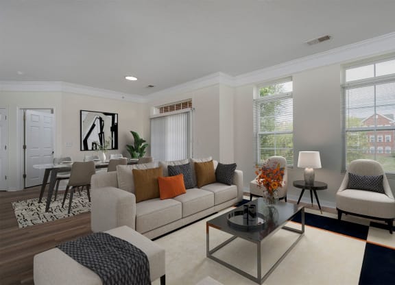 a living room with a couch and chairs and a table