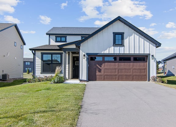 a house with a brown garage door and a driveway
