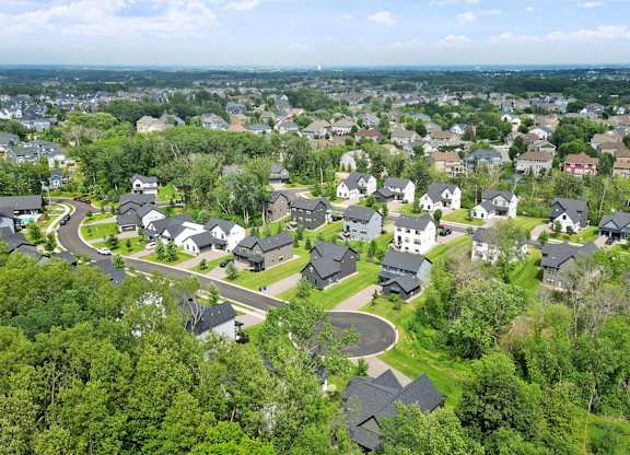 A bird's eye view of a residential area with houses surrounded by greenery.