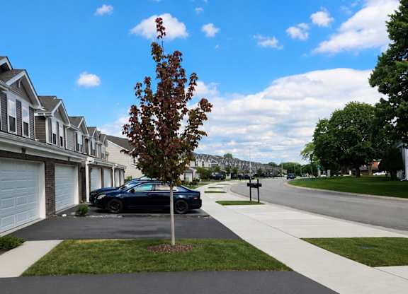 A black car is parked in a driveway.