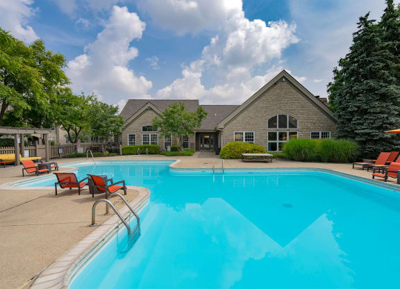 a swimming pool with a house in the background