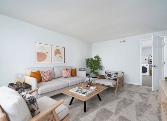a living room with couches and chairs and a table