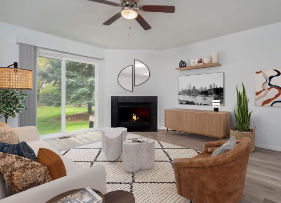 a living room with a couch and chairs and a fireplace