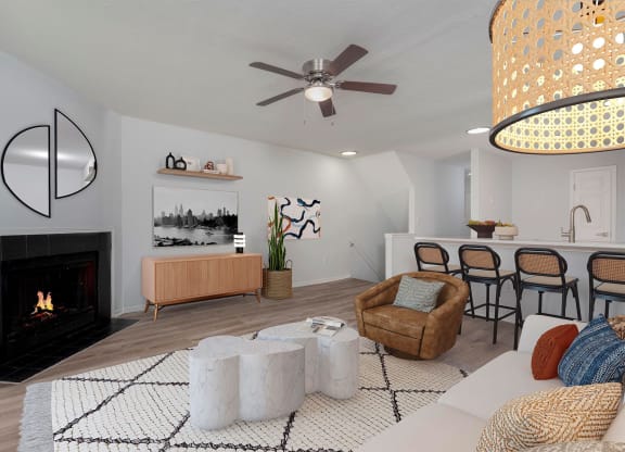 a living room with a fireplace and a table with chairs
