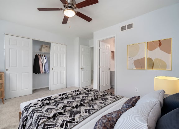 a bedroom with a bed and a ceiling fan