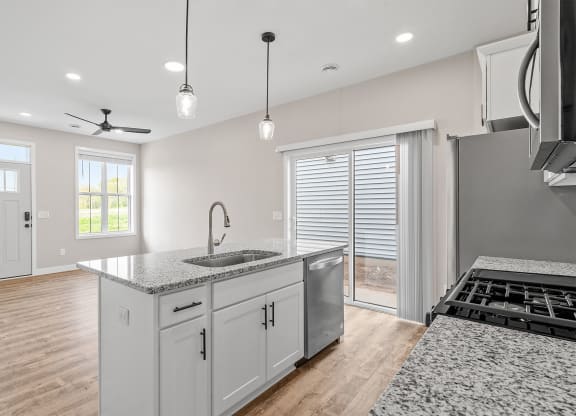 a kitchen with a sink and a stove