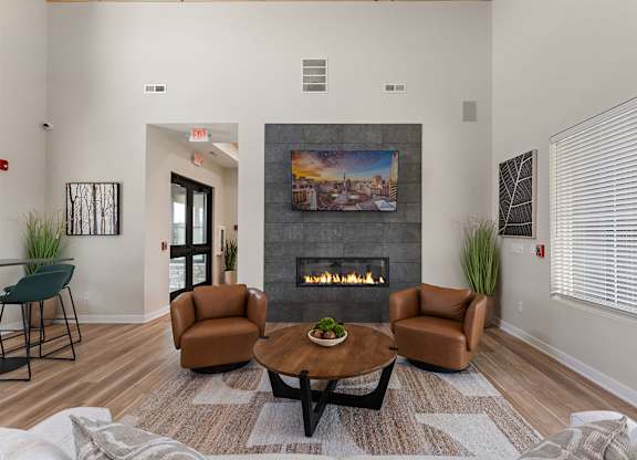 A living room with a fireplace and a painting on the wall.