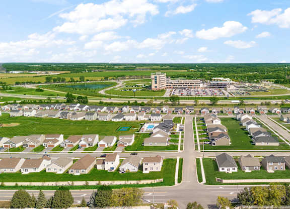 A suburban neighborhood with a large building in the distance.