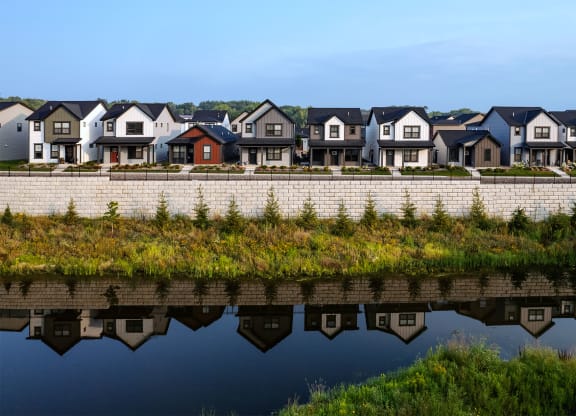 a row of houses reflected in a body of water