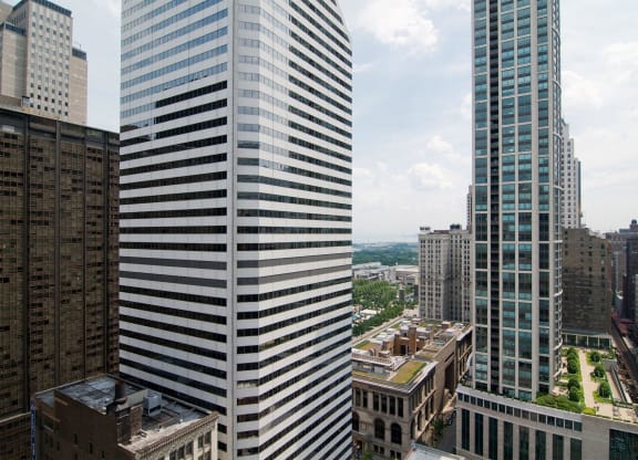 two tall skyscrapers with a city in the background