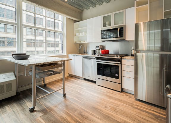 a kitchen with stainless steel appliances and a table
