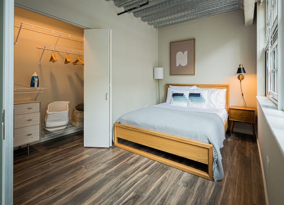 a bedroom with a bed and a bathroom with a shower