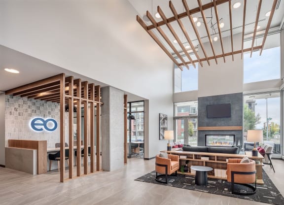 the lobby of a hotel with a couch and a fireplace
