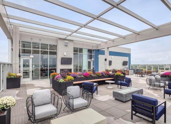 a terrace with chairs and tables and a large glass roof