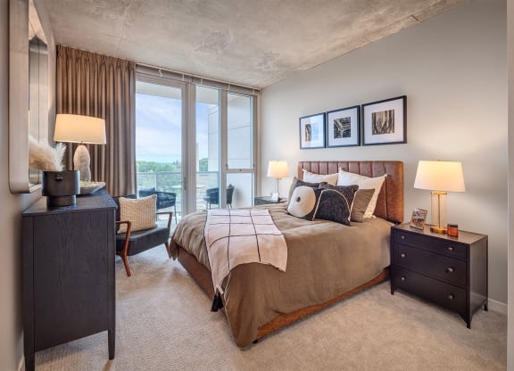 a bedroom with a bed and a large window
