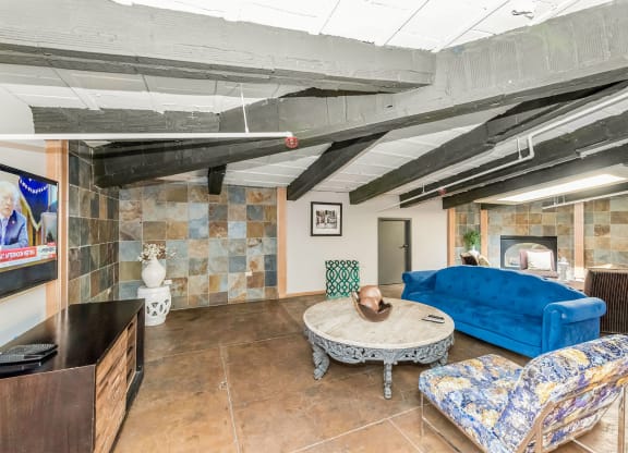 a living room with a blue couch and a table