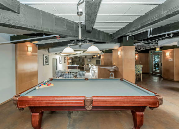 a pool table in the middle of a room in a loft