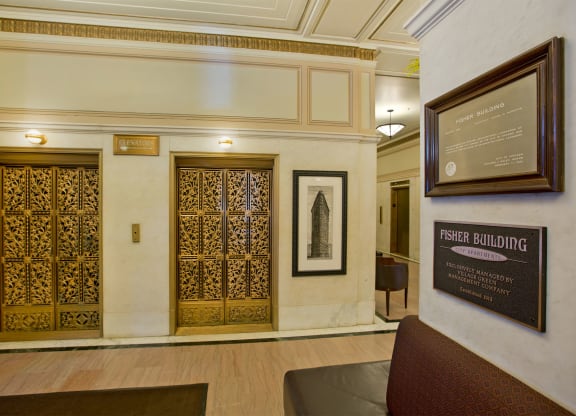 the lobby of a building with two doors and a sign on the wall
