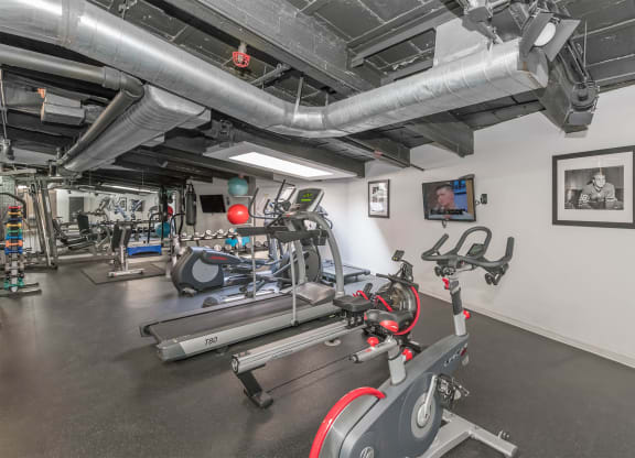 the gym at the district at highland village apartments