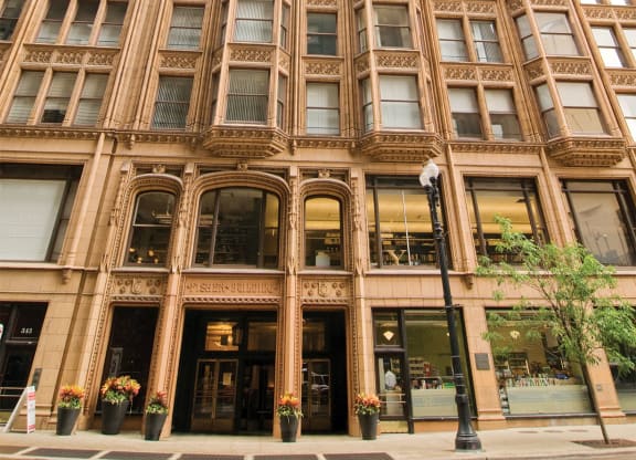 a tall building with many windows and a street in front of it