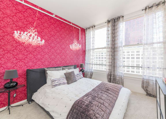 a bedroom with a bed and a red wall