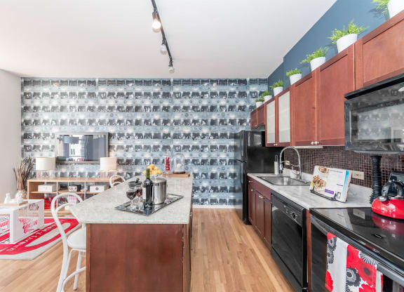a kitchen with black appliances and a counter top