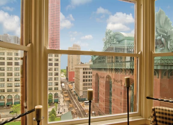 a view of the city from a window of a hotel room