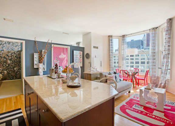 a kitchen with a counter and a living room with a couch