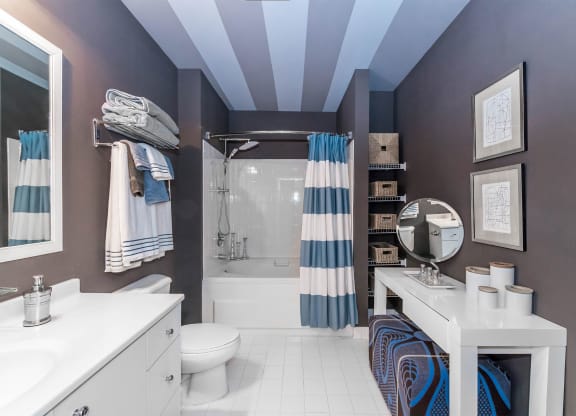 a bathroom with a shower and a sink and a toilet