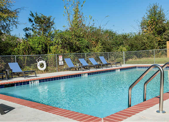 A pool with a metal fence and a sign that says "No Diving".