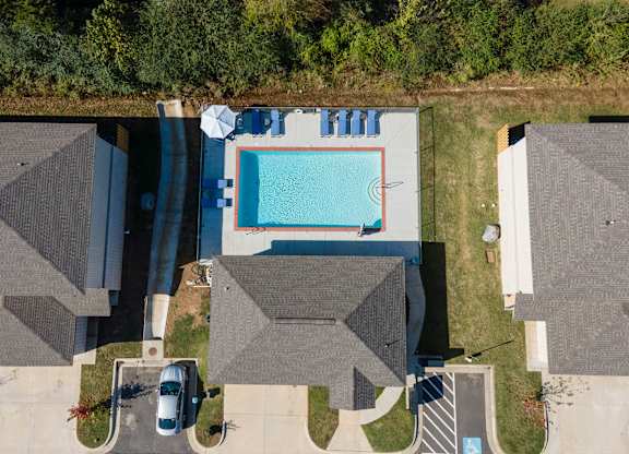 A swimming pool surrounded by houses.