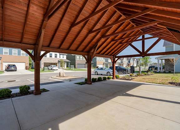 A wooden covered walkway with a concrete floor.