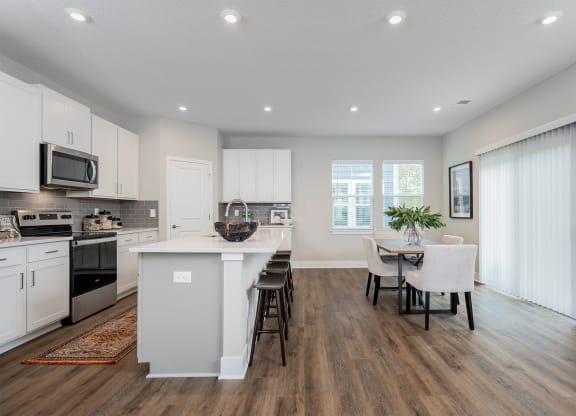 apartment kitchen and living room with island and dining table