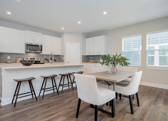 a kitchen and dining room with a table and chairs