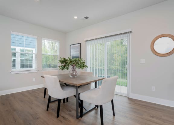 a dining room with a table and chairs and a window