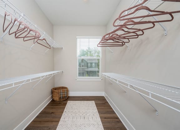 large walk in closet with two rows of shelves