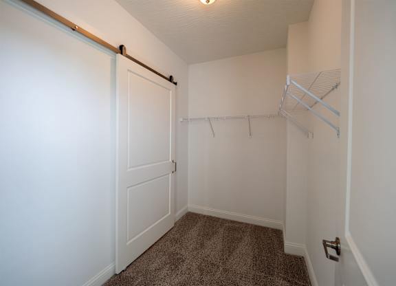 A white door with a handle and a white wall.