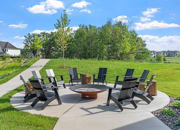 A set of chairs and tables are arranged in a circle on a patio.