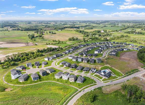 A bird's eye view of a residential area with houses and roads.
