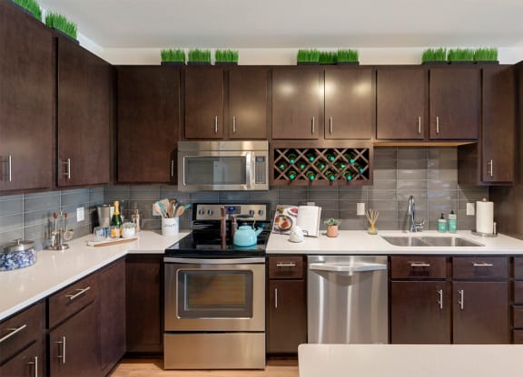 a modern kitchen with stainless steel appliances and wooden cabinets