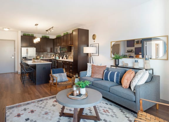 a living room and kitchen with a couch and a table