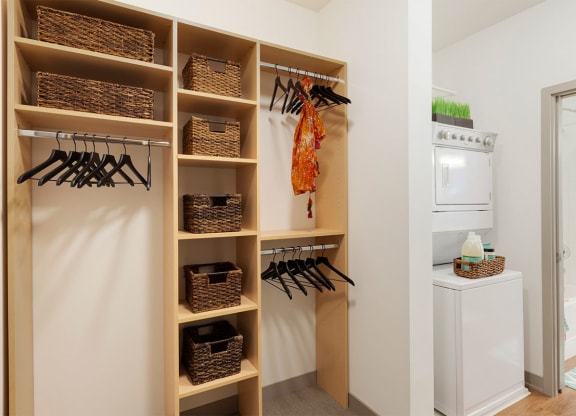 a laundry room with a closet and a washer and dryer