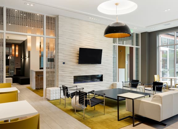 a living room with a table and chairs and a fireplace