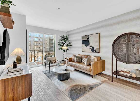 A living room with a couch, a coffee table, and a large mirror.