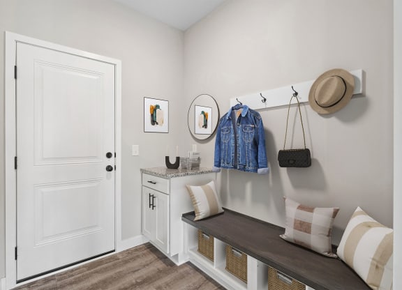 a bedroom with a dresser and a hat on the wall