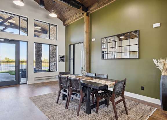 A dining room with a wooden table and chairs.