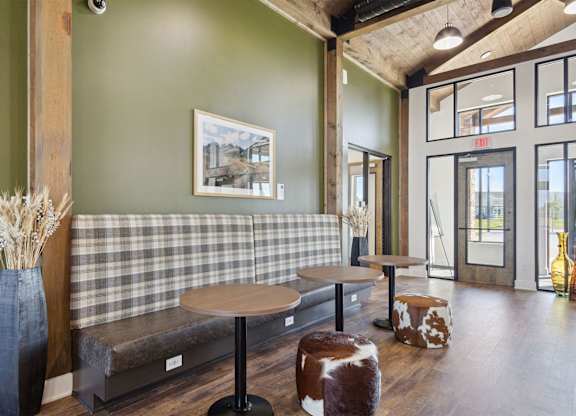 A room with a green wall and a checkered bench.